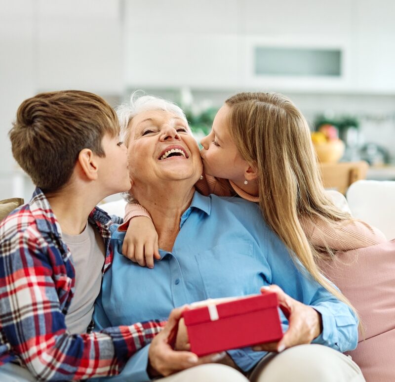 Granddaughter,And,Grandson,Surprises,Her,Grandmother,With,Present,On,Mother's