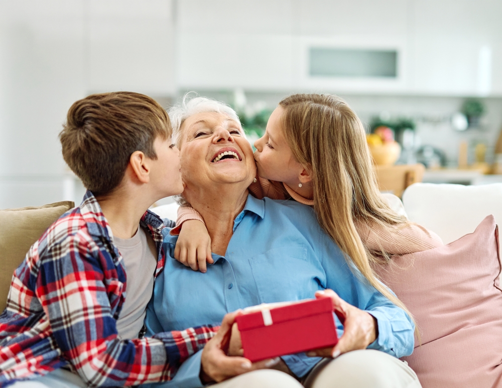 Granddaughter,And,Grandson,Surprises,Her,Grandmother,With,Present,On,Mother's